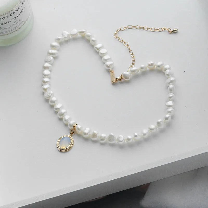 White geometric pendant on an adjustable sterling silver necklace chain.