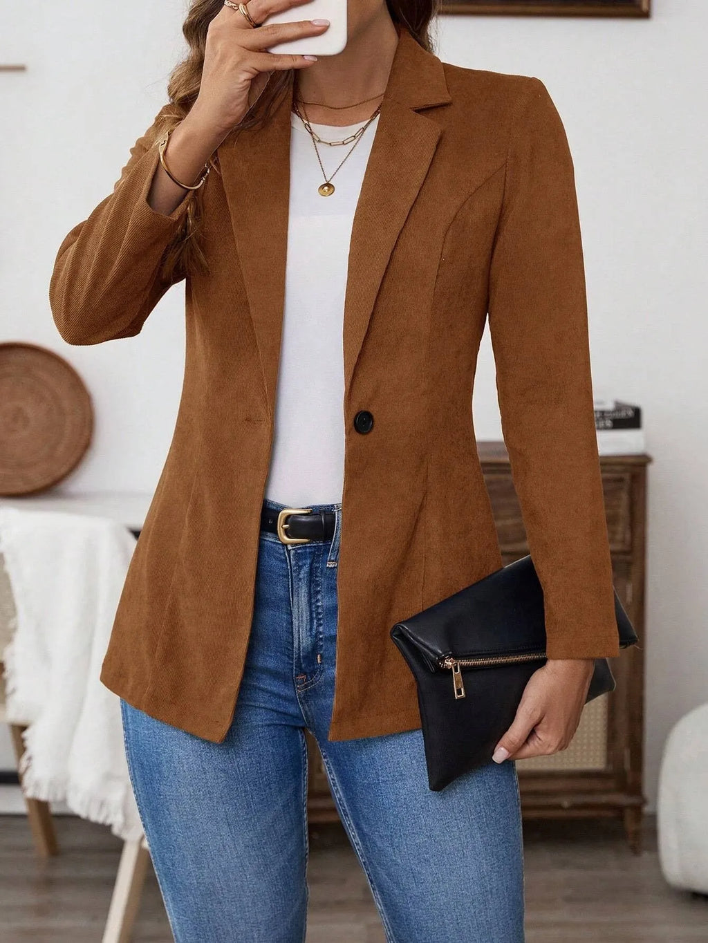 Brown men's single-breasted leisure suit coat with lapel collar on a hanger.