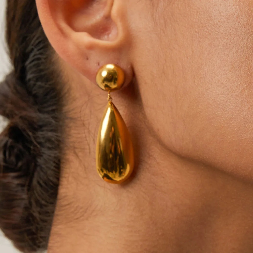 Gold-coloured stainless steel earrings with geometric water drop hemisphere pendant design