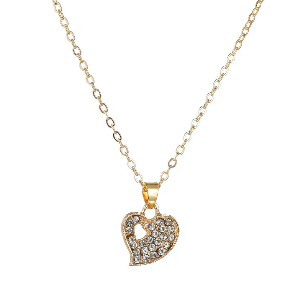 Gold jewellery set with earrings, pendant and adjustable bracelet showing love, water drop and bell motifs