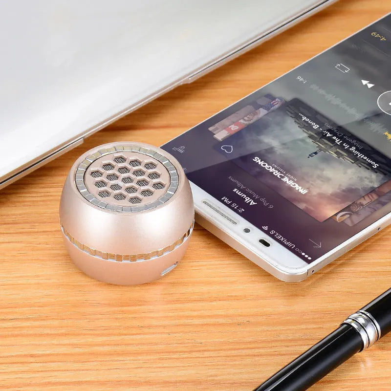 Universal external amplifier speaker in black, gold, or rose gold, showing input for 5V charger.