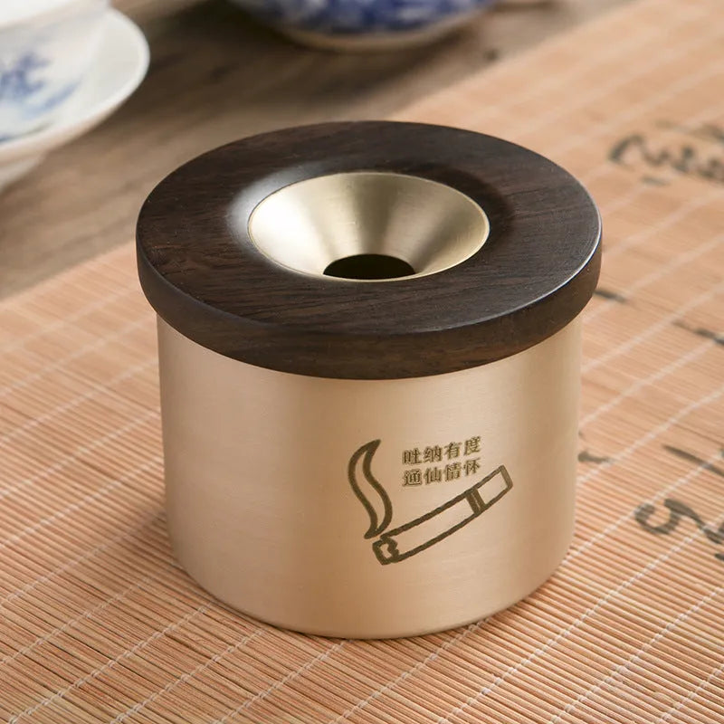 Brass ashtray with a wooden lid featuring a central hole, shown in black wood and red wood options.