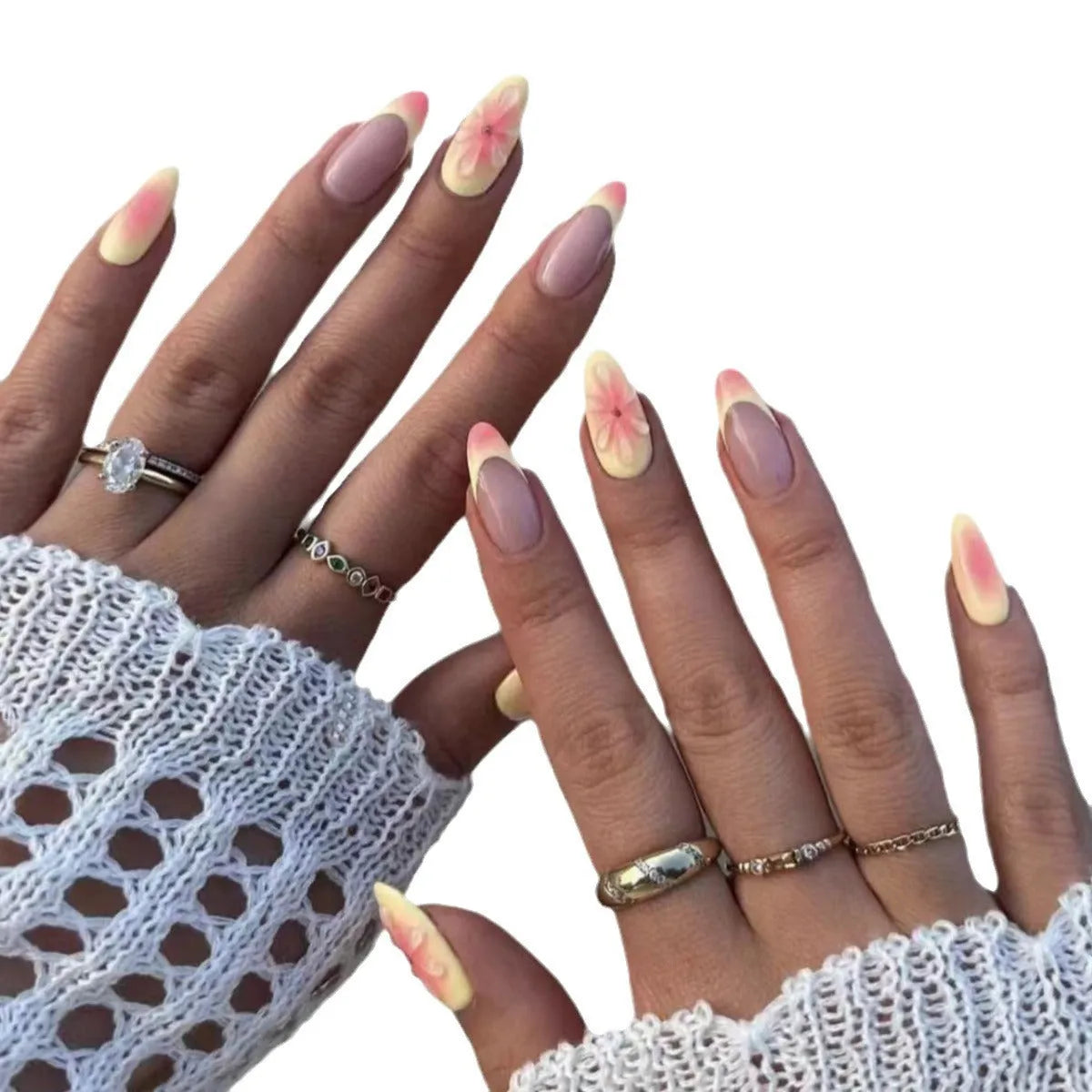 Set of simple fake nails with pink and white cartoon 3D flower charms on a wearable armour base.