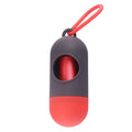 Compact black dog poop bag holder with Velcro strap and metal side hook, shown next to a roll of waste bags.
