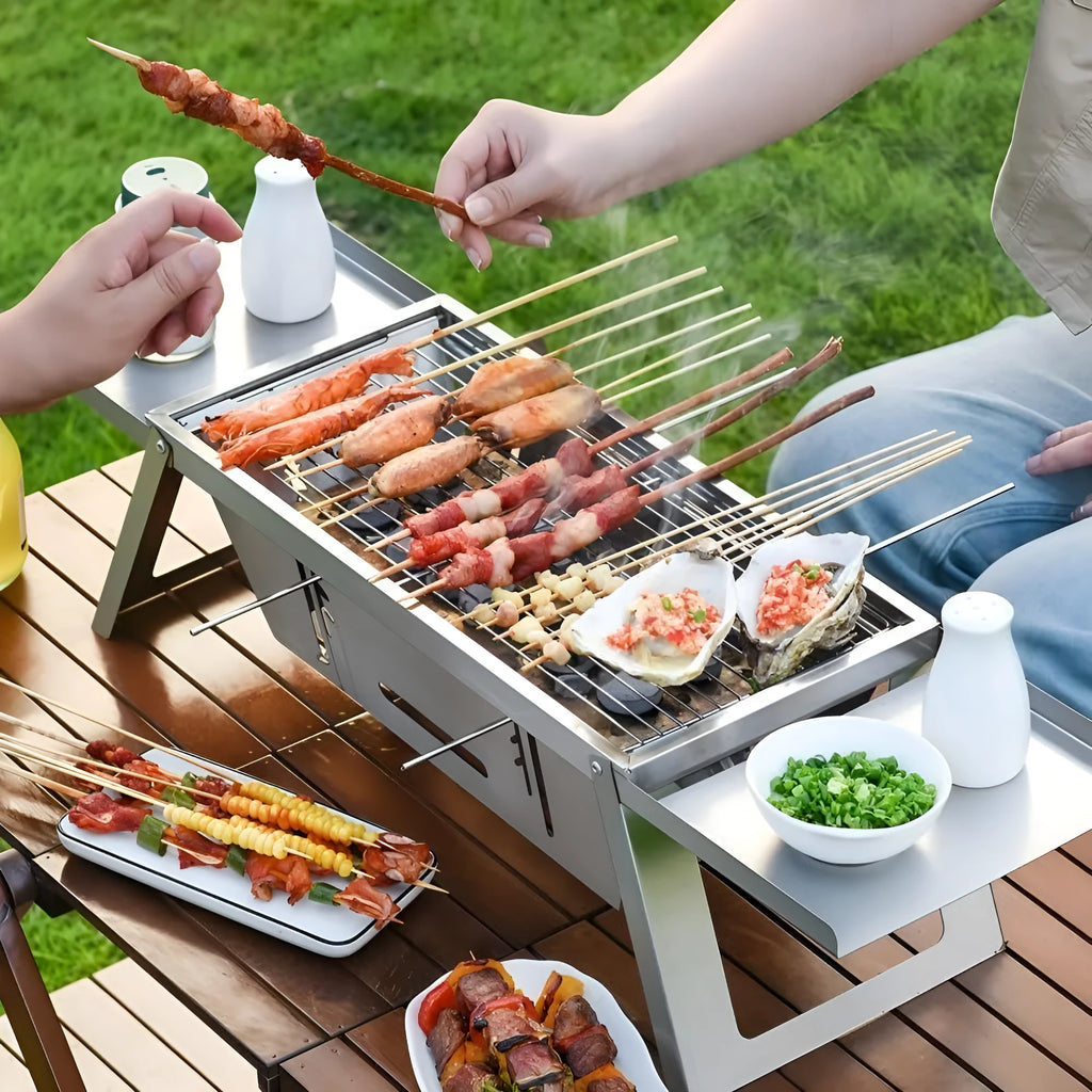 Small foldable portable charcoal grill for outdoor use.