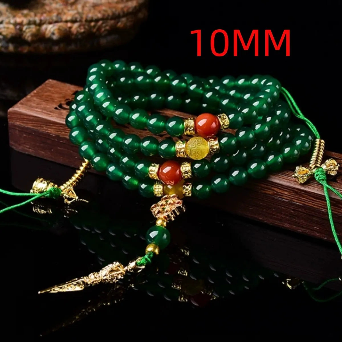 Natural green agate multi-strand bracelet with sliding knot closure on a wrist.