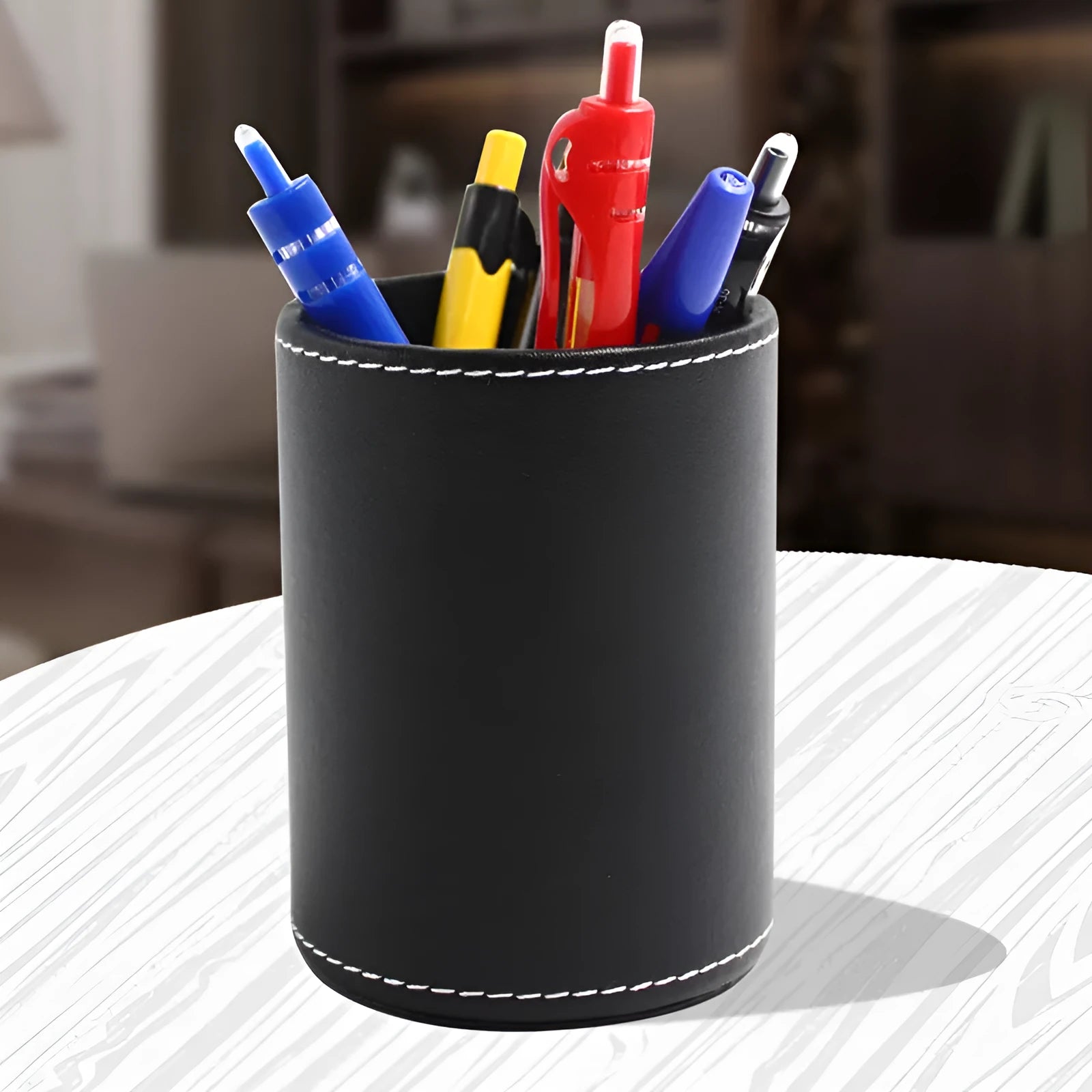 Small round black leather pen container showing dimensions