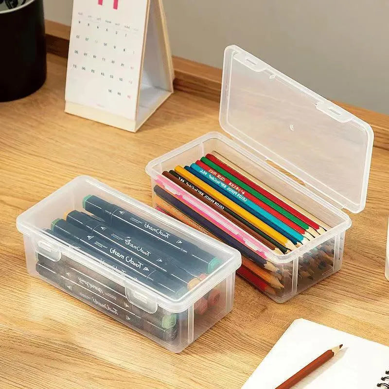 Large clear plastic stationery storage box filled with coloured pencils and wax crayons