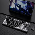 87-key wired mechanical gaming keyboard with hot-swappable switches shown in a two-tone colour scheme on a metal chassis.
