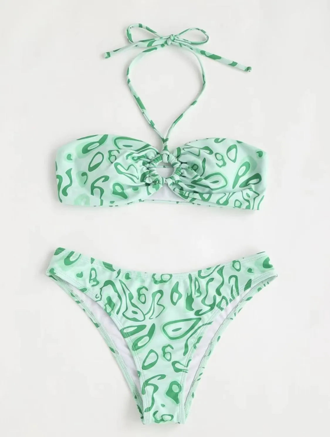 Green floral bandeau bikini swimsuit with split design on a mannequin