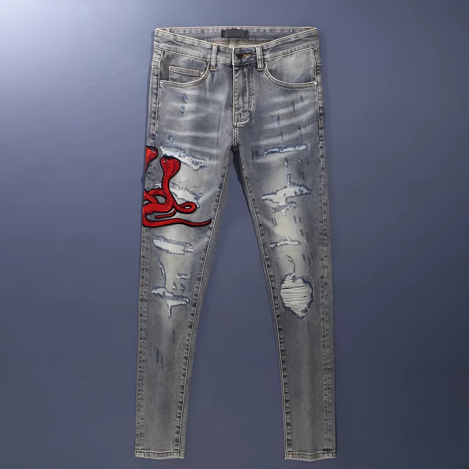 Slim fit jeans with washed-out old colour, distressed holes, and embroidered patches on cotton fabric