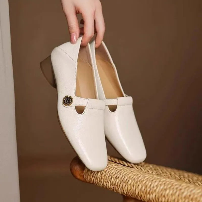 Retro square head genuine leather women shoes in beige with mid heel and square heel on a grey background