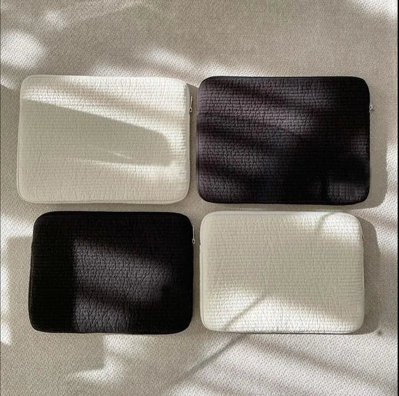 Black and white cotton clutch-style anti-seismic laptop bag for tablet protection.