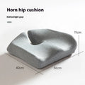 Dark grey memory foam office chair cushion with contoured shape for lower back support on a desk chair.