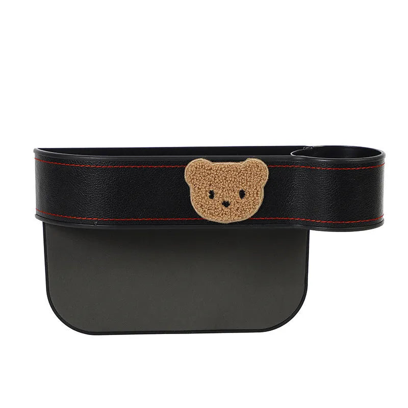 PU leather car seat gap storage box hanging between vehicle seats for small item organisation.