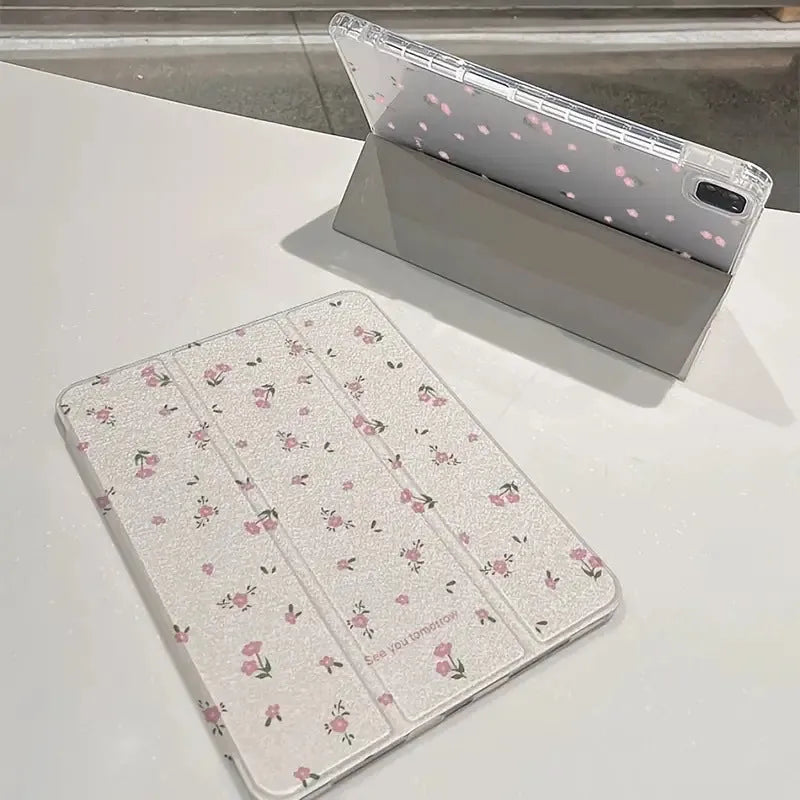 Clear tri-fold iPad case with floral design, shown in stand mode.