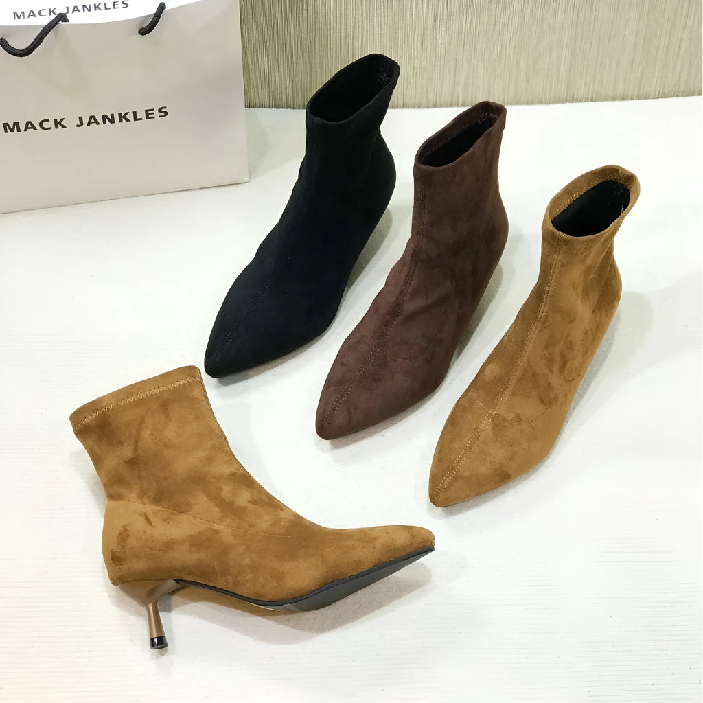 Women's black pointed toe ankle boots with stiletto heel and mid-calf height