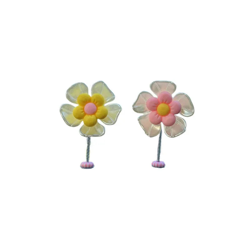 Small colourful plastic swing car decoration hanging ornament in blue, green, pink, purple, or yellow.