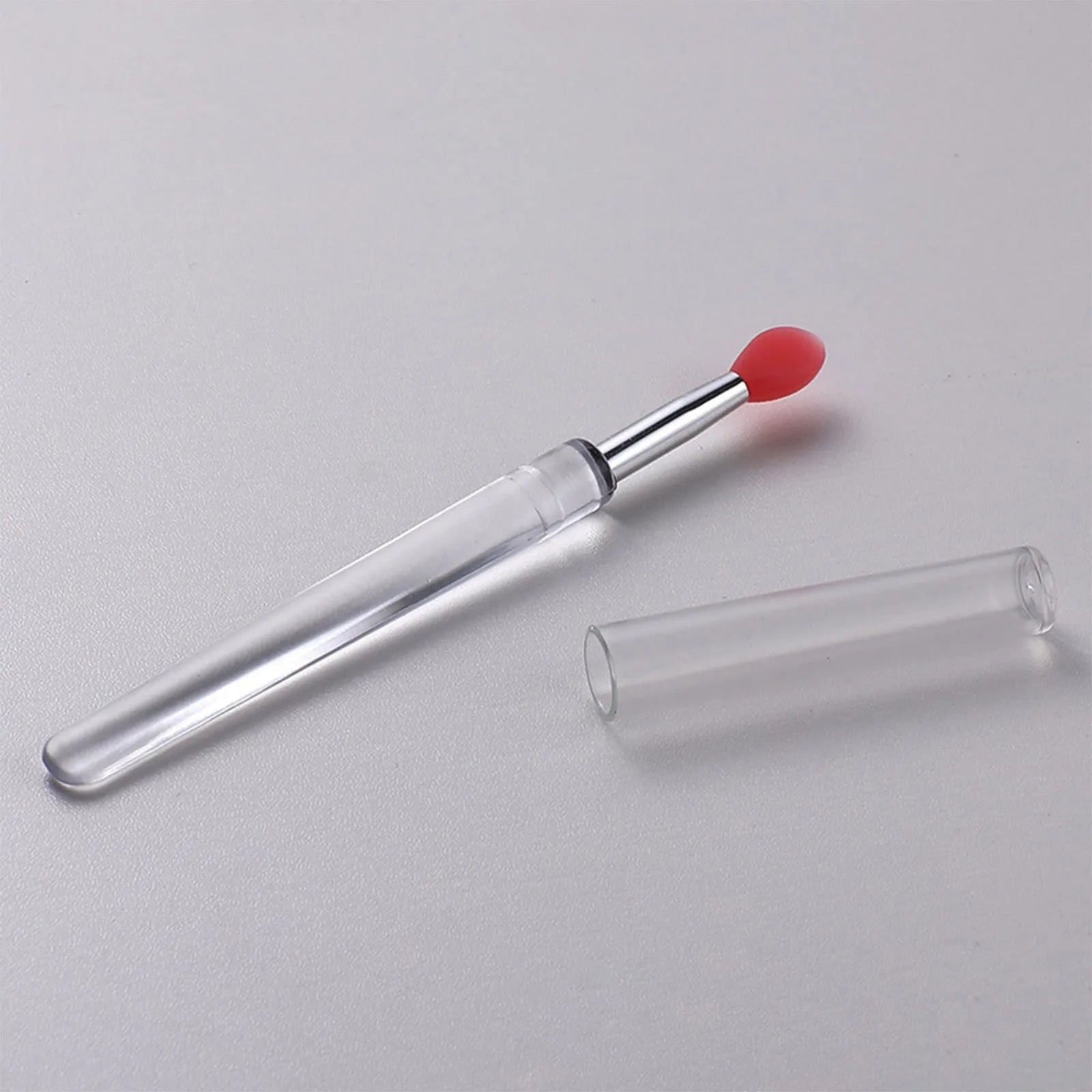 Silicone lip brush with protective cap for hygienic lip product application