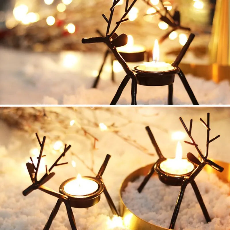 Black iron Christmas candlestick holder with decorative elk design on a table.