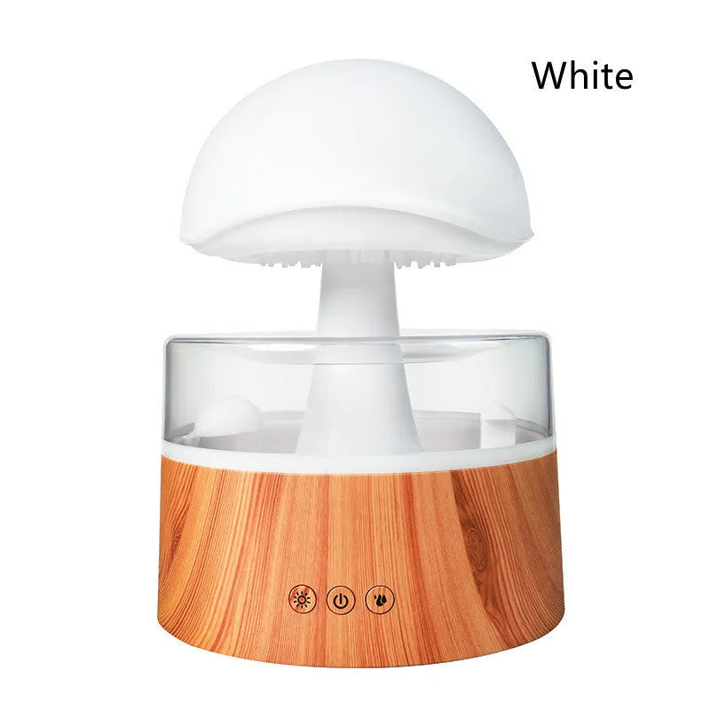 White cloud-shaped humidifier and aroma diffuser with LED lights and mist output on a wooden table.