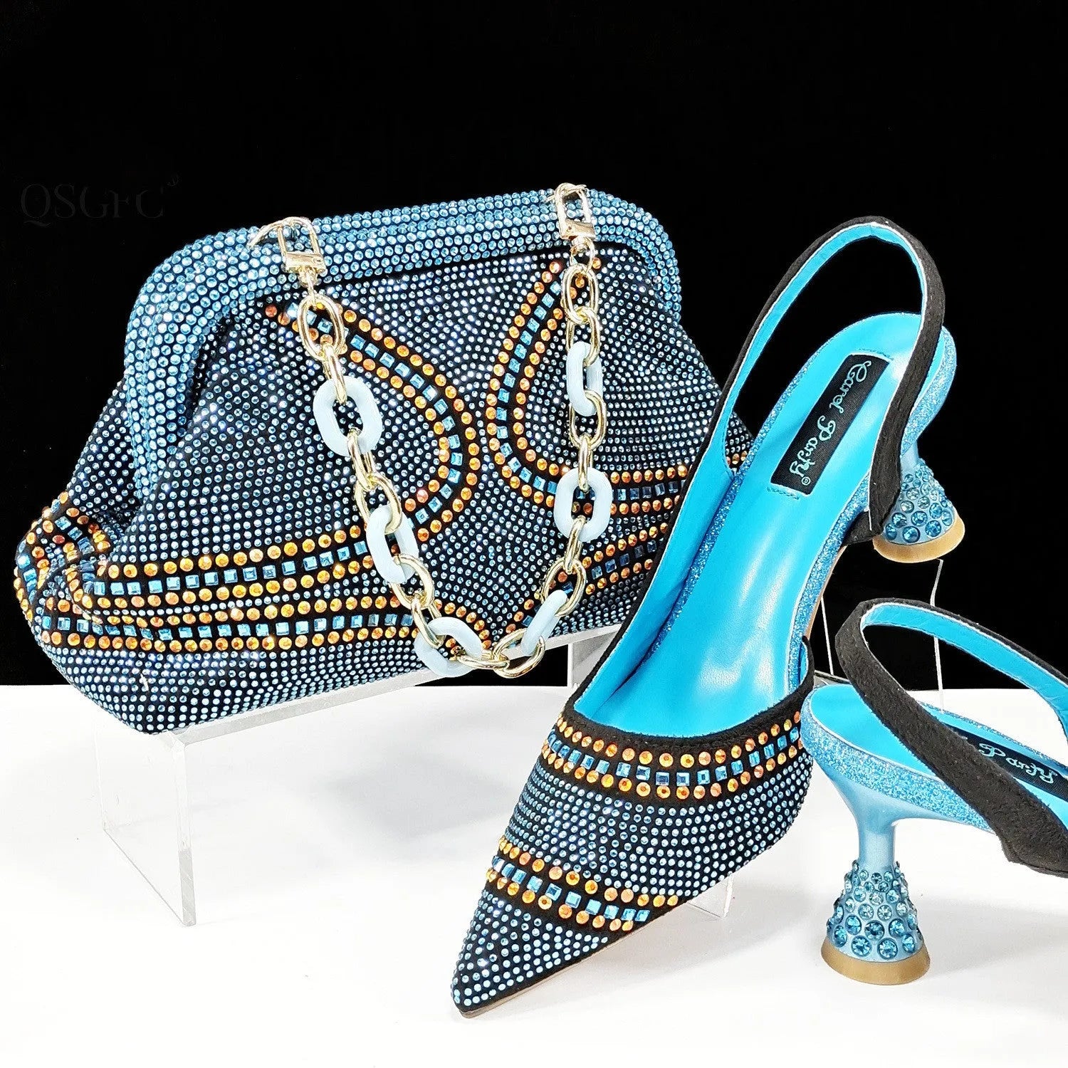 Women's pointed-toe high heel shoes with matching bag, featuring a stiletto heel and rhinestone detail on a synthetic leather upper.