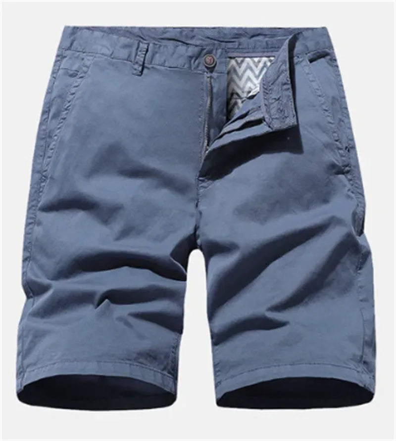 Man wearing loose-fit blue denim casual shorts with no belt, showcasing straight leg design.