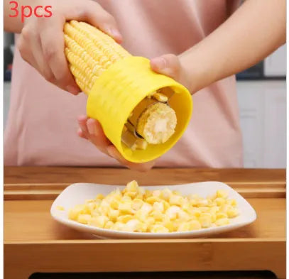 Yellow manual corn grinder thresher with corn-shaped design and PP plastic grip.