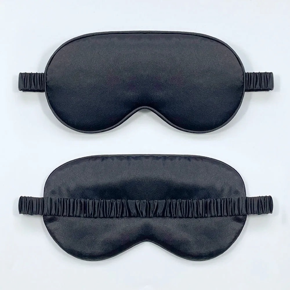 Reversible silk-like sleep eyeshade shown in multiple colour options including sky blue, wine red, and black.