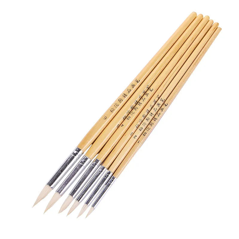 Six wooden-handled art brushes with pointed wool tips arranged together