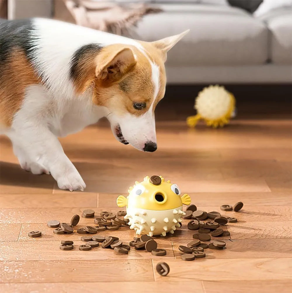 Green fish-shaped dog chew toy with treat dispensing hole and textured surface