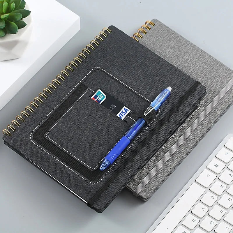 A5 erasable coil notebook with stone paper and pen on wooden surface
