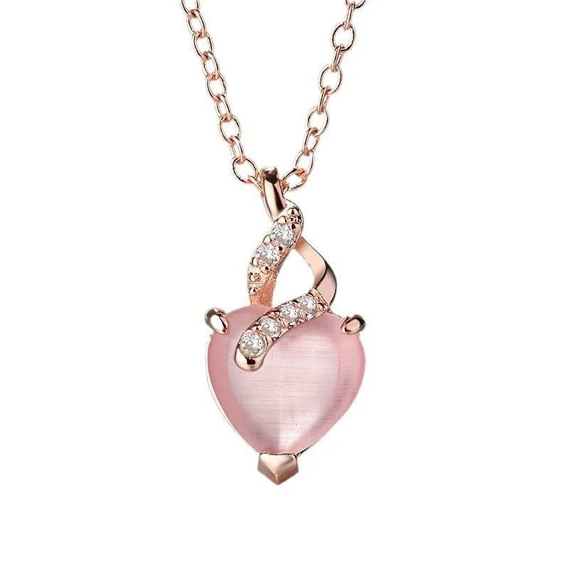 Women's rose gold heart pendant necklace with pink crystal on cross chain