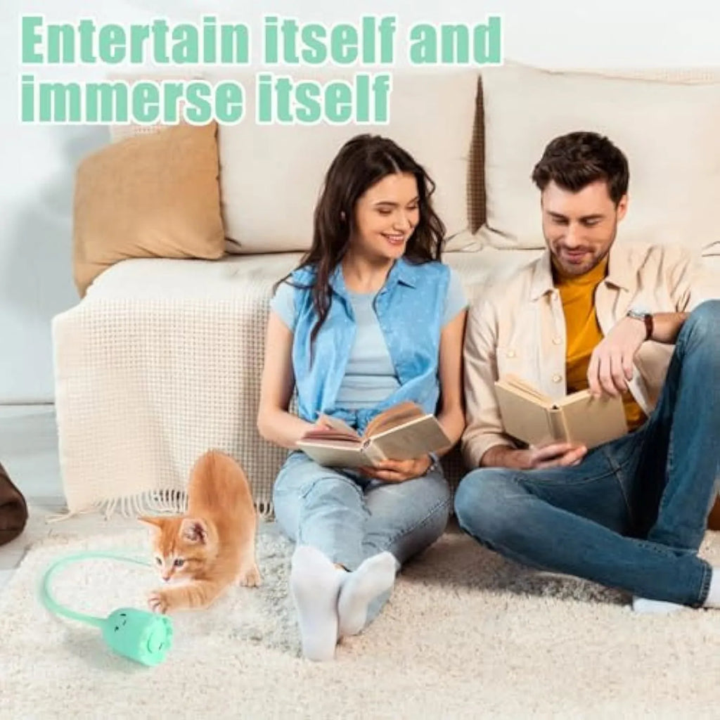 Green electronic cat toy with swinging silicone tail on floor for indoor cat play