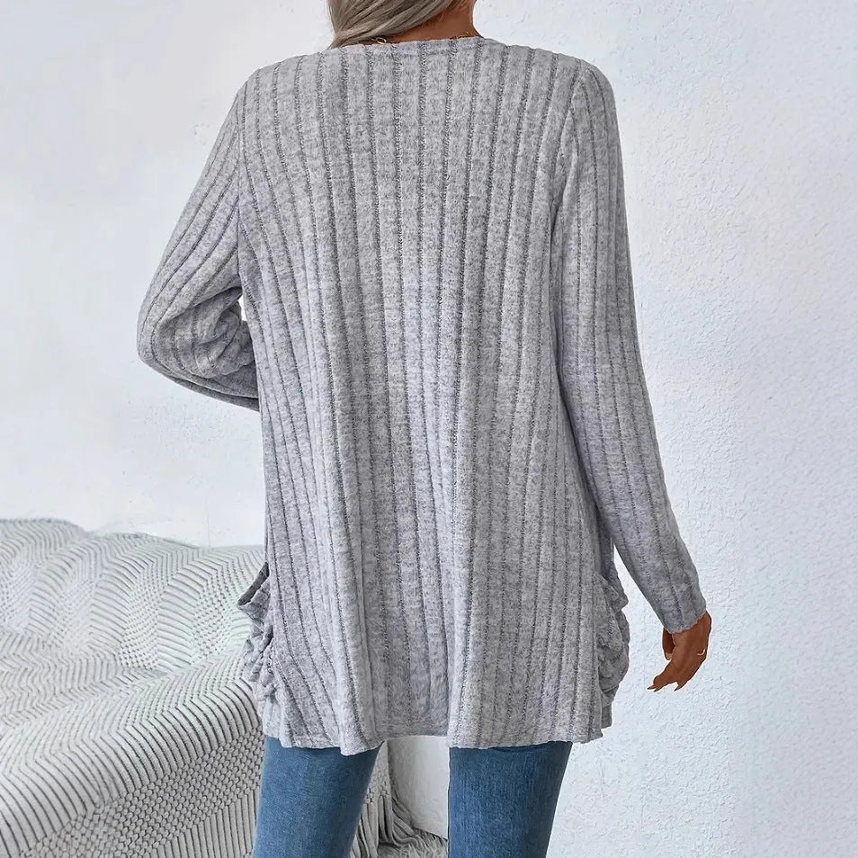 A loose-fit, solid colour long sleeve cardigan for women with a chest pocket, shown in grey and black.