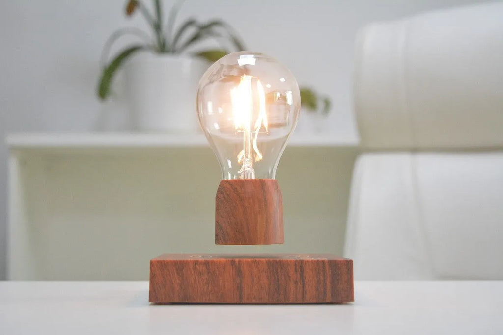 Magnetic levitation floating light bulb with UK plug on imitation wood base.