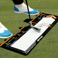 Black neoprene golf swing posture correction pad on a green surface