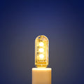 Small cylindrical USB baby night light showing warm yellow glow on a dark background.