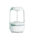Black anti-gravity humidifier showing water droplet backflow effect with USB cable