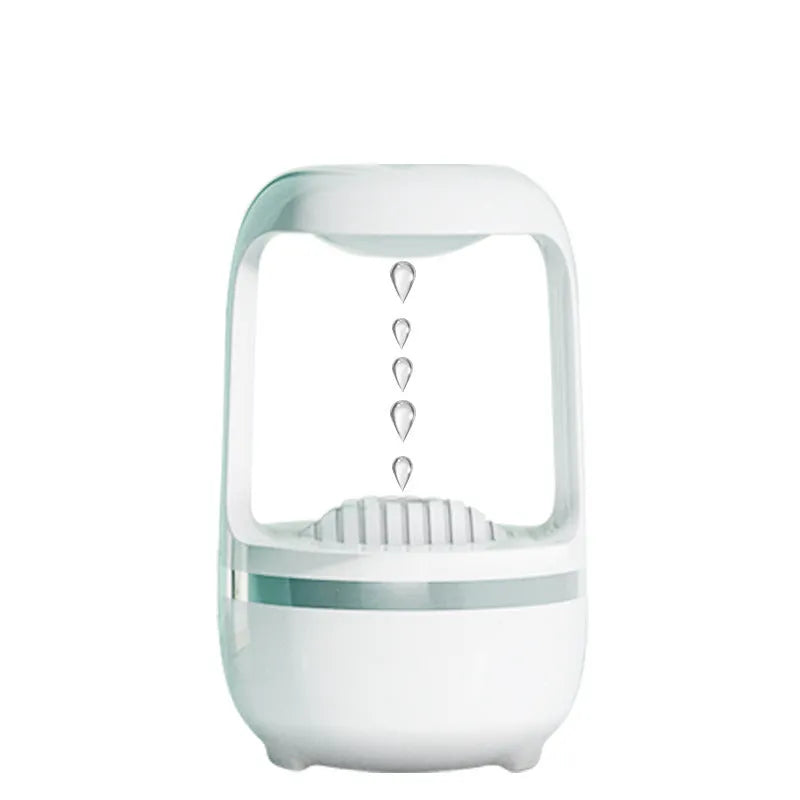 Black anti-gravity humidifier showing water droplet backflow effect with USB cable