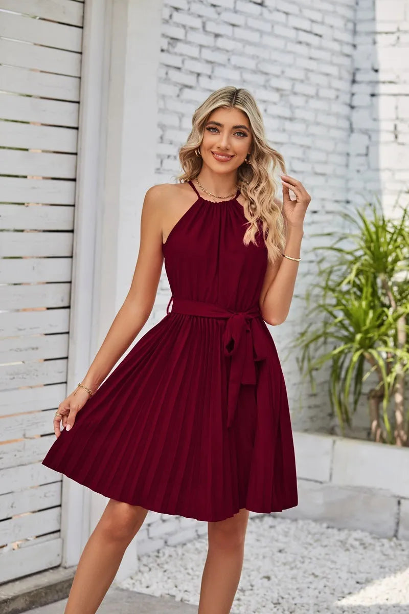 Women's black halter-neck strapless chiffon dress with pleated midi skirt and adjustable waist belt