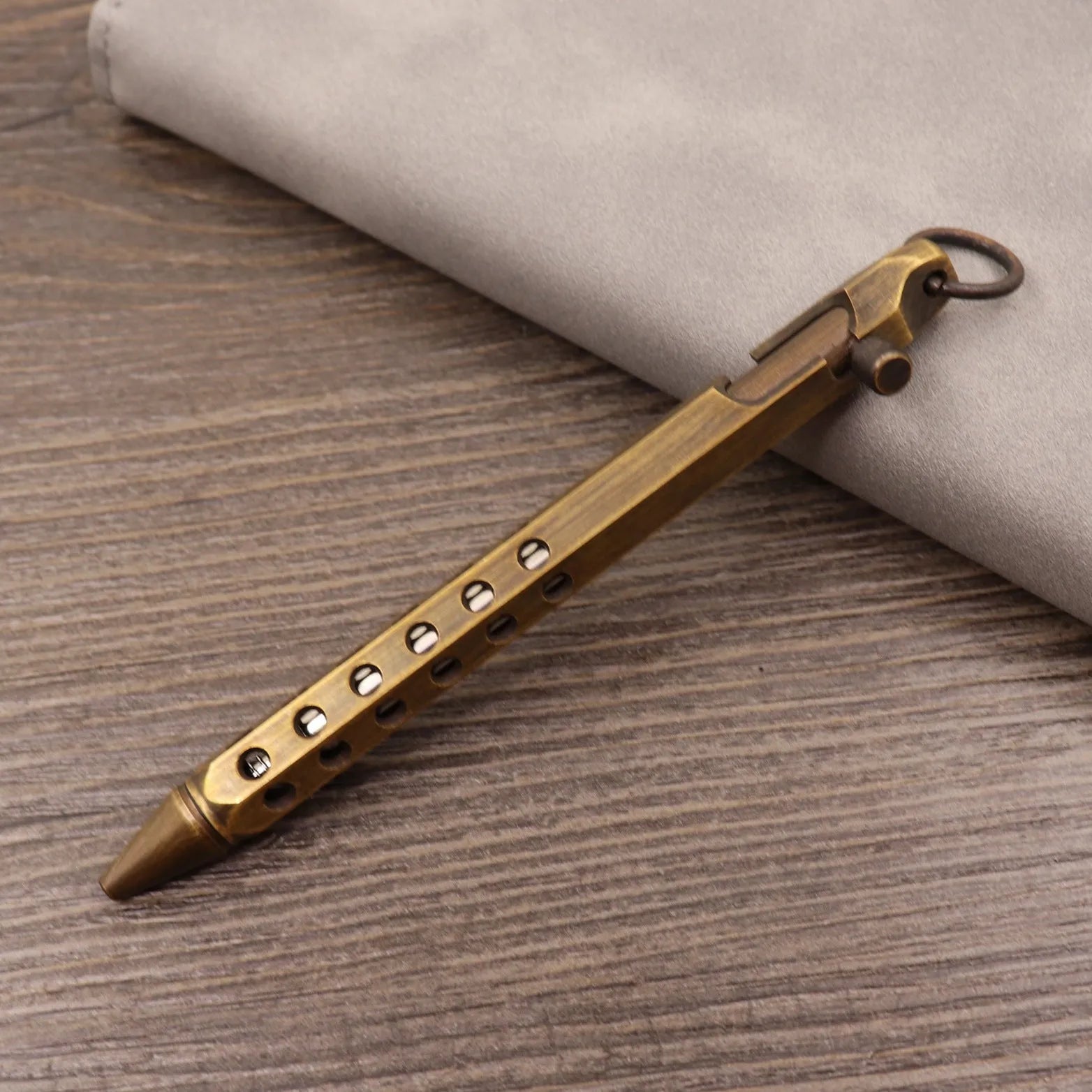 Retro brass tactical pen with bolt action mechanism in brushed natural finish
