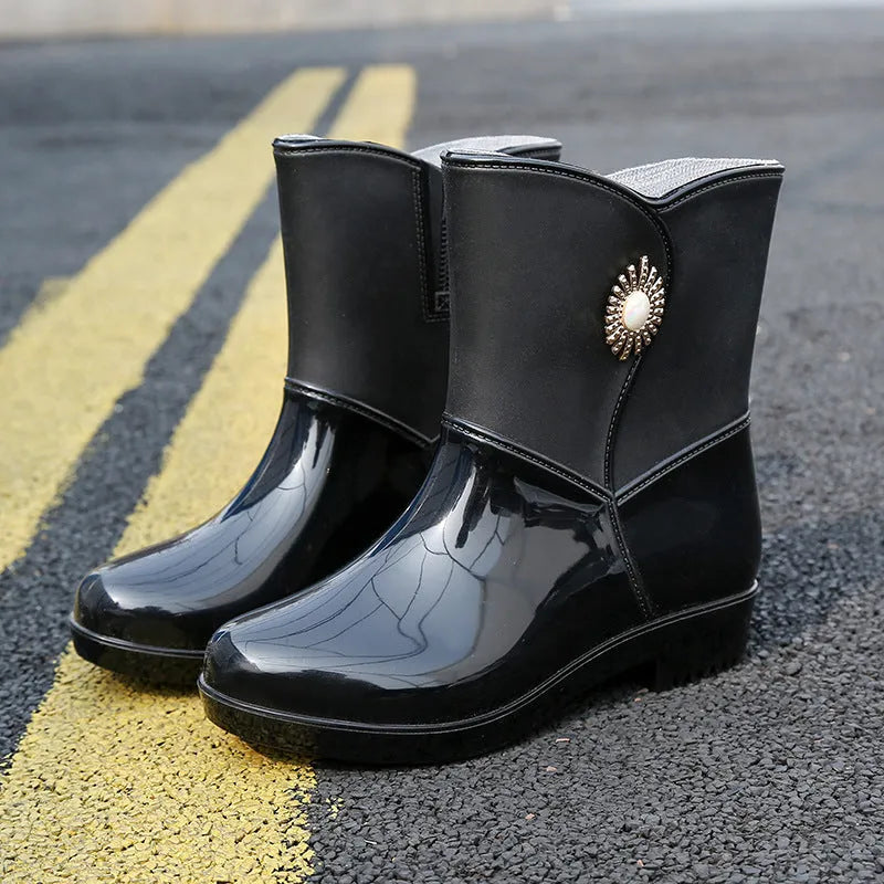 Women's mid-calf rain boot in purple PVC with a non-slip sole and low tube design.