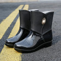 Women's mid-calf rain boot in purple PVC with a non-slip sole and low tube design.