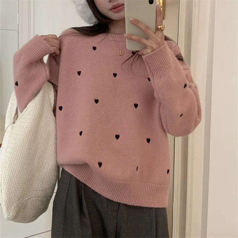 Women's loose grey acrylic pullover sweater with embroidery detail on the front, featuring long sleeves and a crew neck.