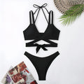 Women's solid colour strap beach bikini swimsuit in a briefs style, shown in one of five colour options.