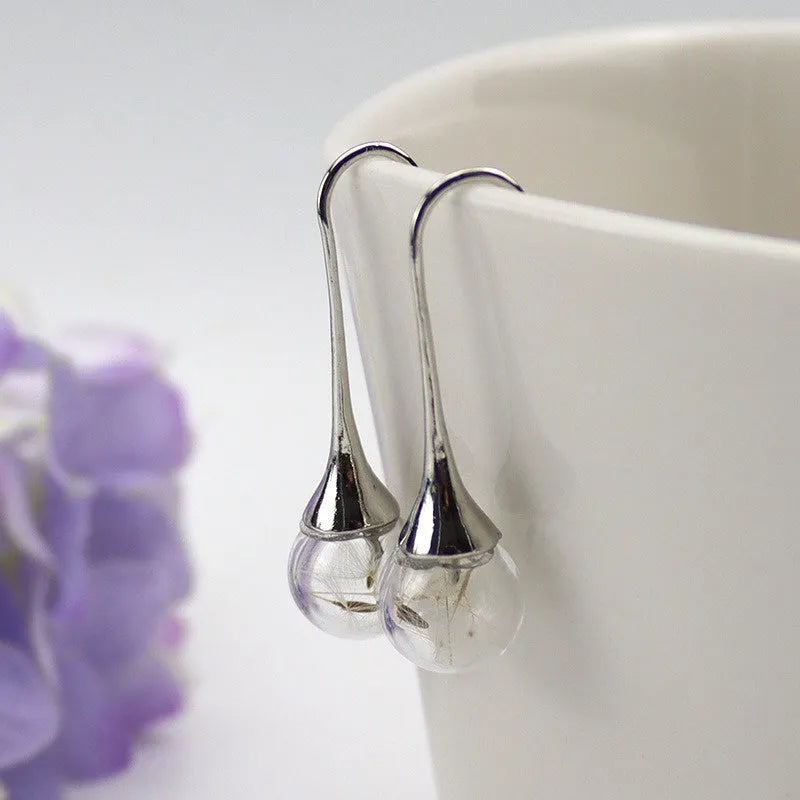 Transparent glass ball earrings with dandelion design and French hook options in silver and bronze finishes
