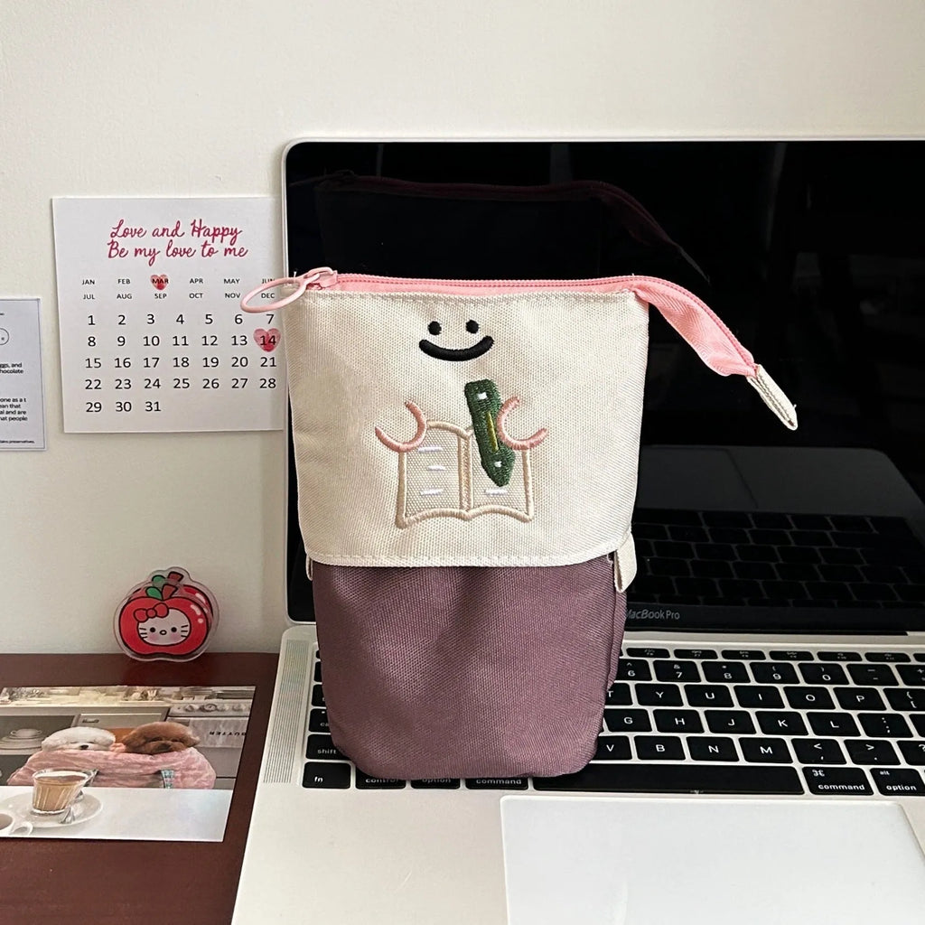 Brown Korean-style cartoon collapsible pencil case made from Oxford fabric, shown open.