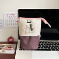 Brown Korean-style cartoon collapsible pencil case made from Oxford fabric, shown open.