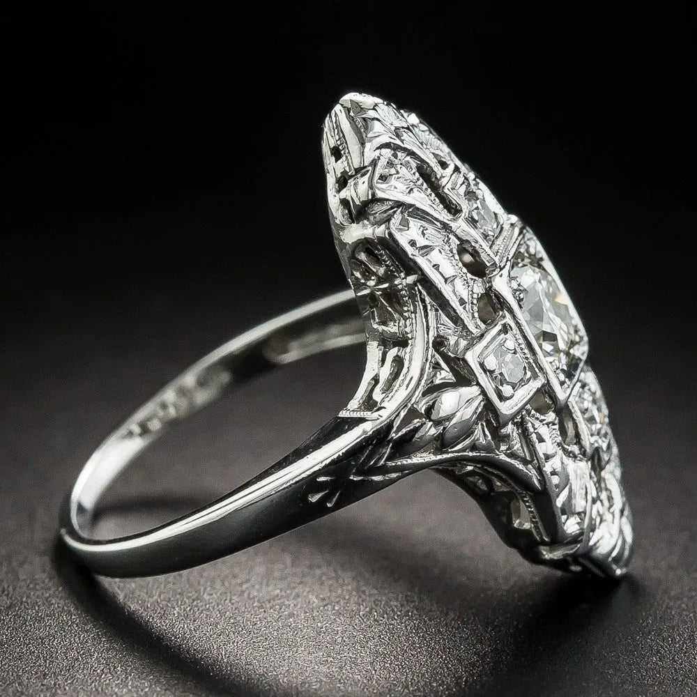 Geometric hollow out copper ring with silver electroplating and diamond stud accents on a grey background.